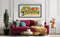 Living room with a red sofa, colorful pillows, and a framed picture of children playing outdoors.