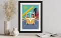Framed artwork of a vintage van with a colorful background on a table.