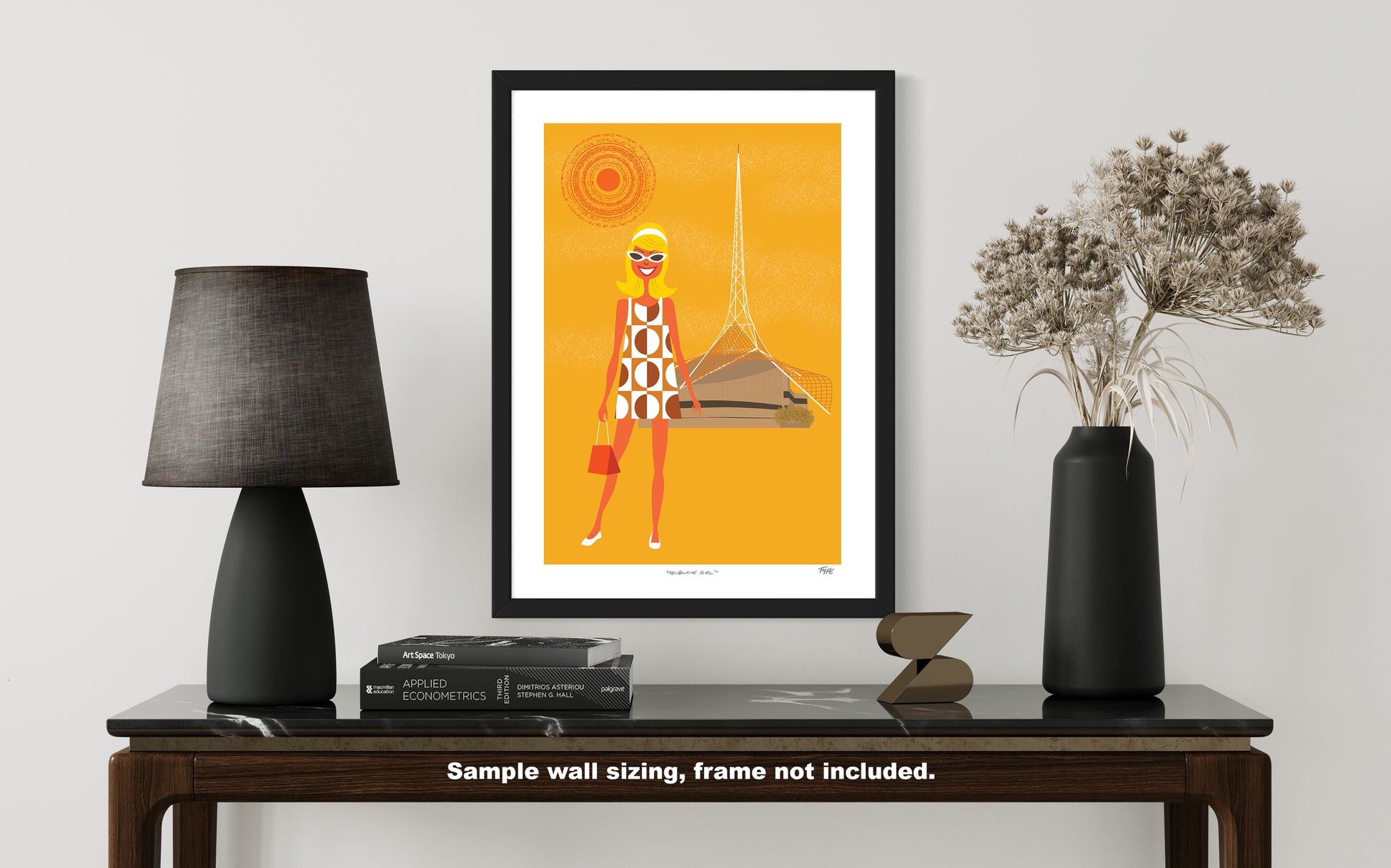 Framed artwork of a stylized figure on a table with decor items.