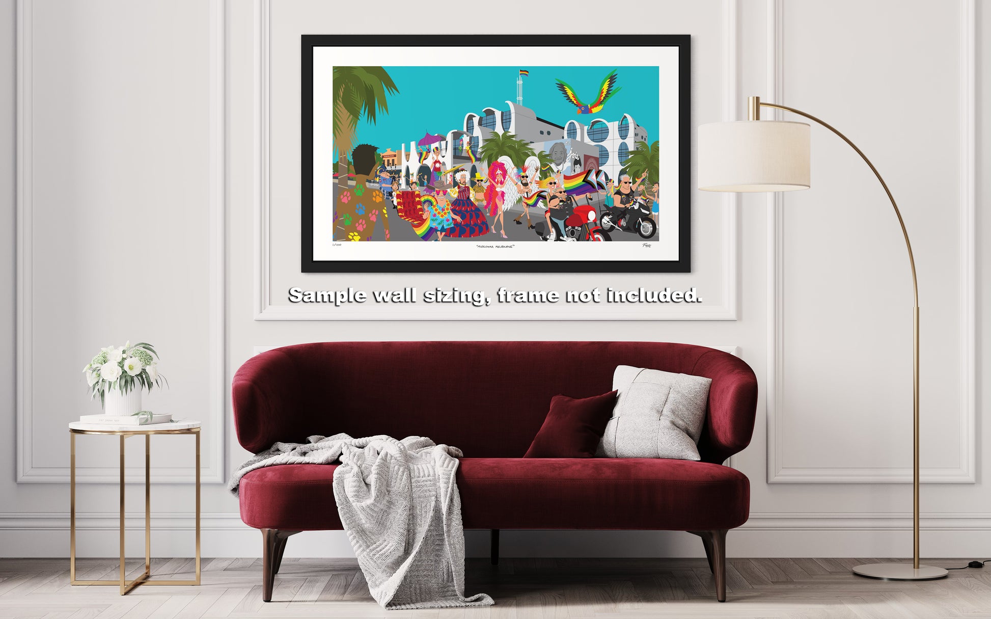 Framed artwork of a colorful cityscape with people on a wall above a red sofa.