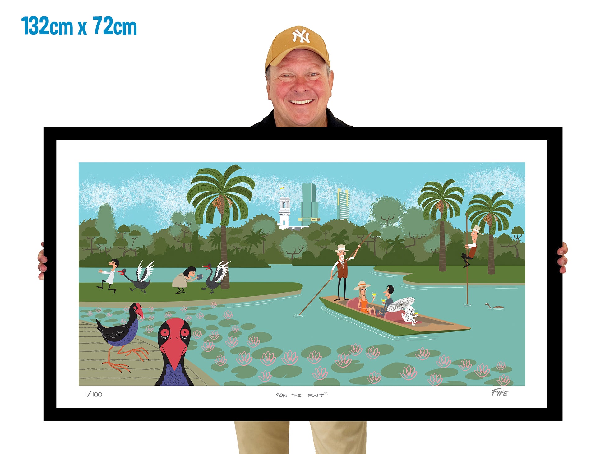 Person holding a framed artwork of a park scene with people and ducks.