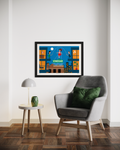 Framed artwork on a wall above a gray armchair with a green pillow.