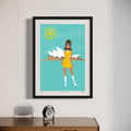 Framed artwork of a woman in a yellow dress with the Sydney Opera House in the background, on a white wall.