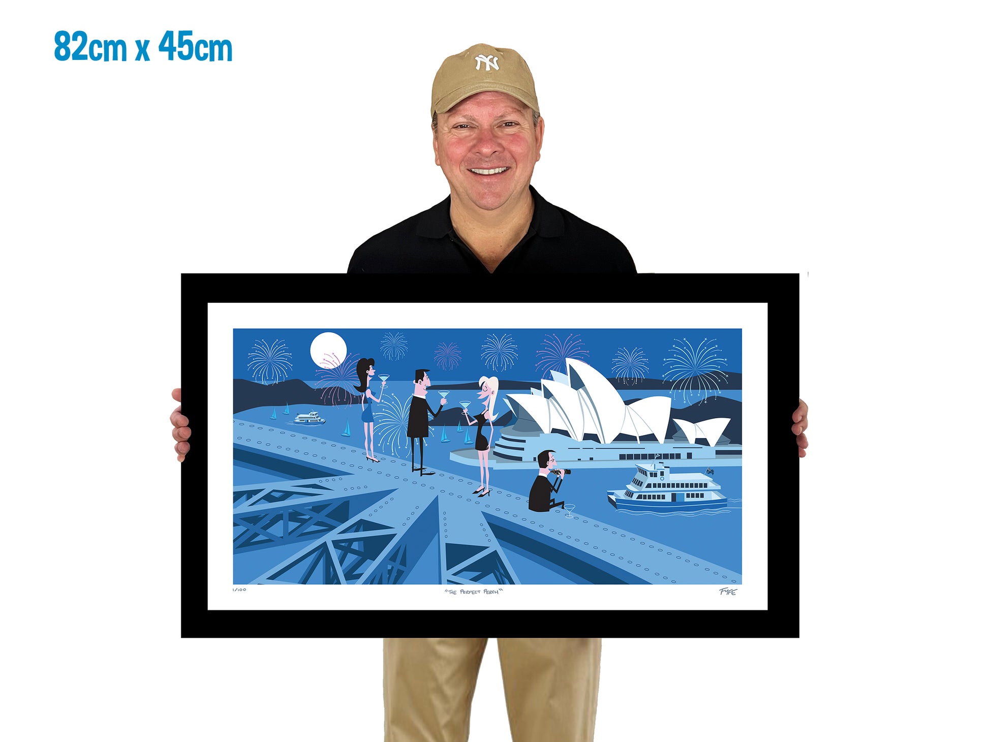 Man holding a framed artwork of the Sydney Opera House with dimensions displayed.