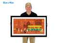 Man holding a framed artwork of a city scene with a tram and people on a white background