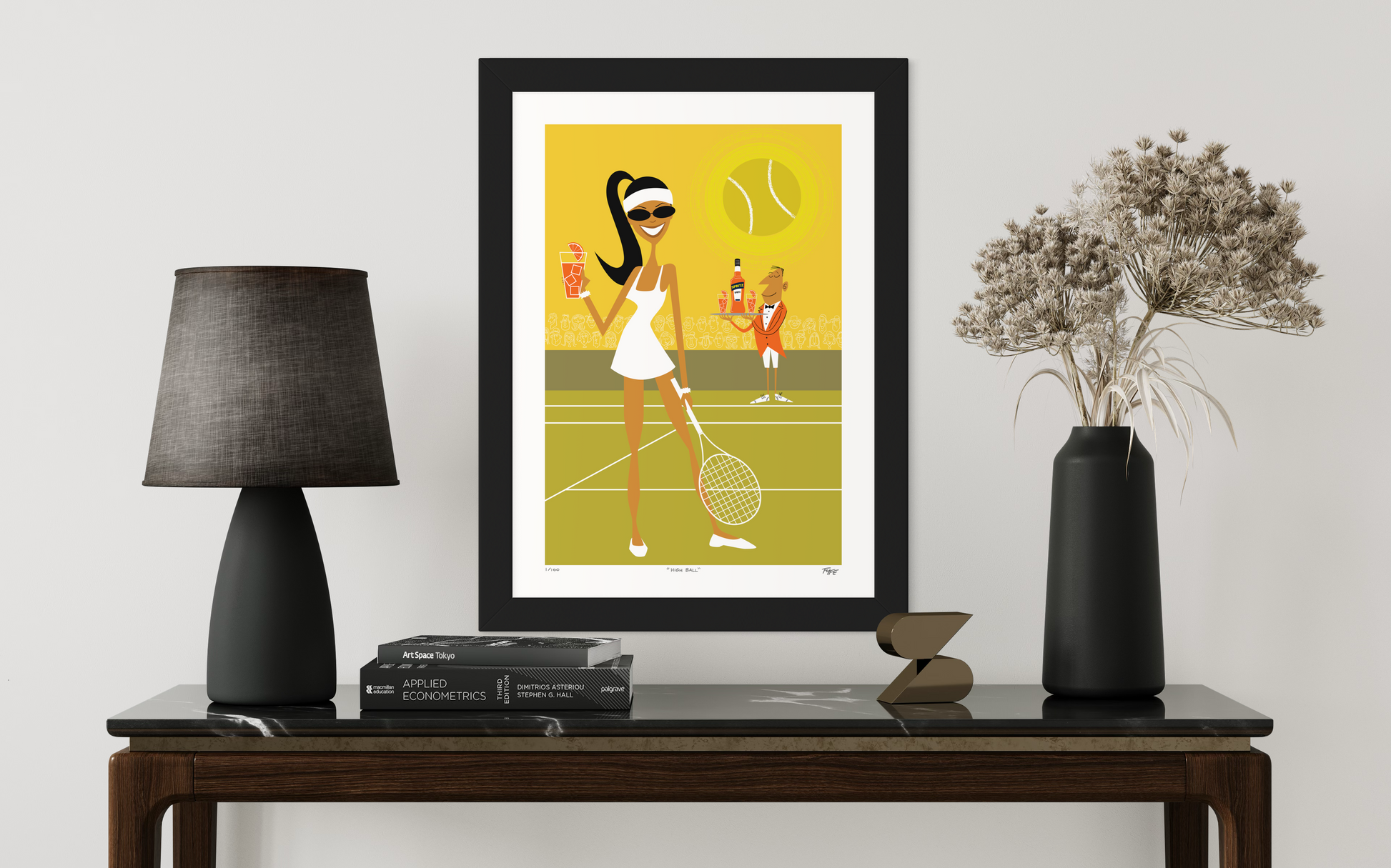 Framed artwork of a woman playing tennis on a table with decor items.