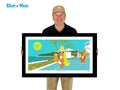 Man holding a framed artwork of a tropical scene with people by the pool.