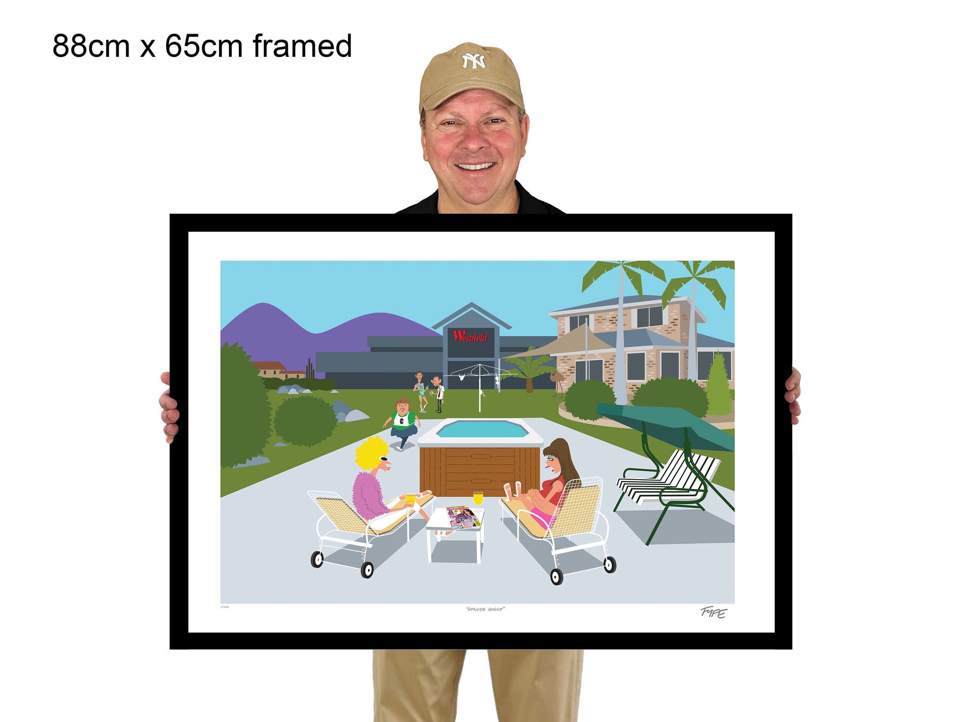 Man holding a framed artwork of a cartoon scene with people by a pool.