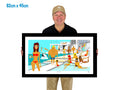Man holding a framed artwork of people by a pool