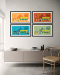 Four framed artworks on a wall above a cabinet with a chair.