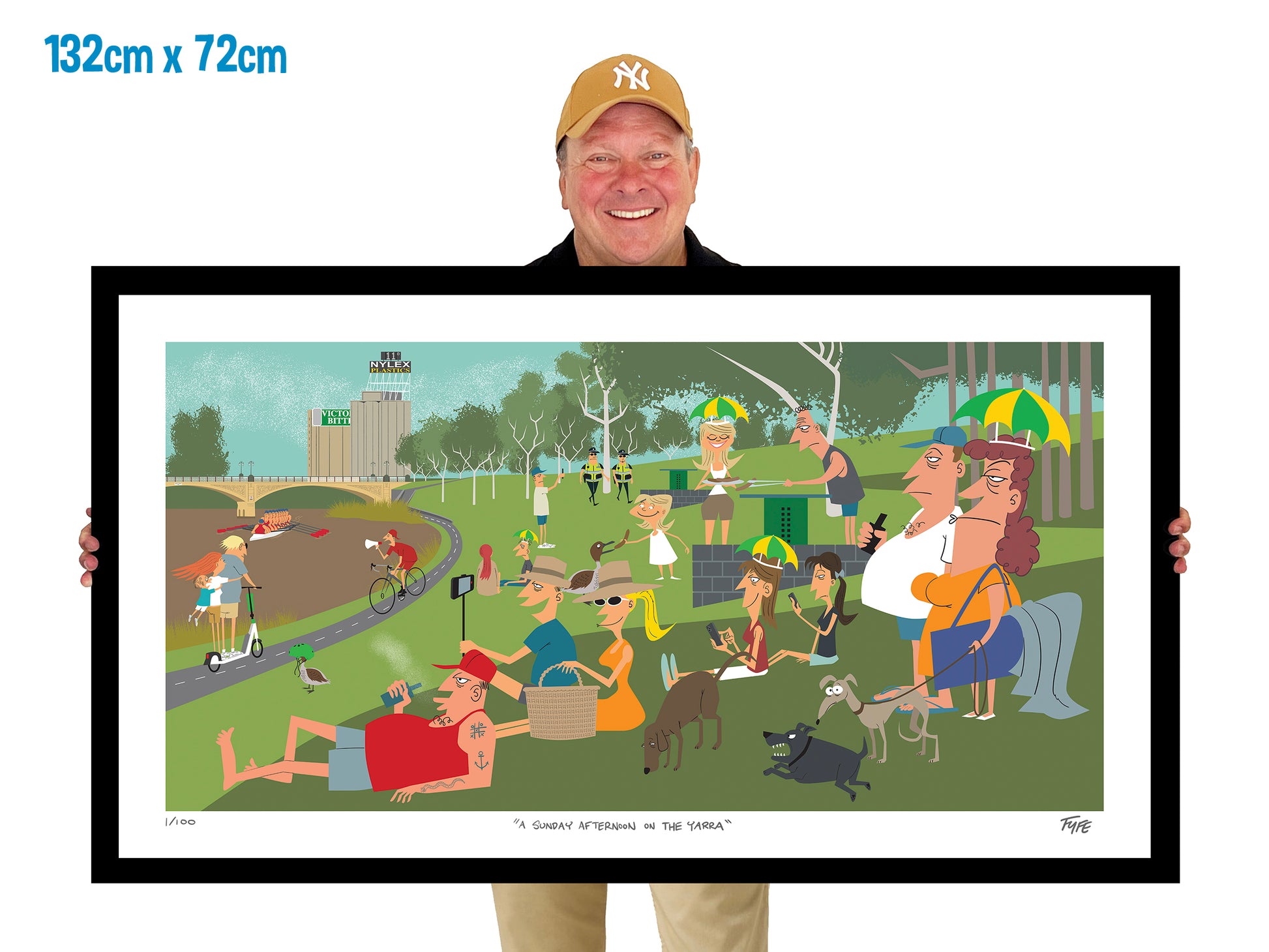 Person holding a large framed artwork of a park scene with people and animals.