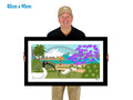 Man holding a framed artwork of a bridge, flowers, and birds with '82cm x 45cm' text.