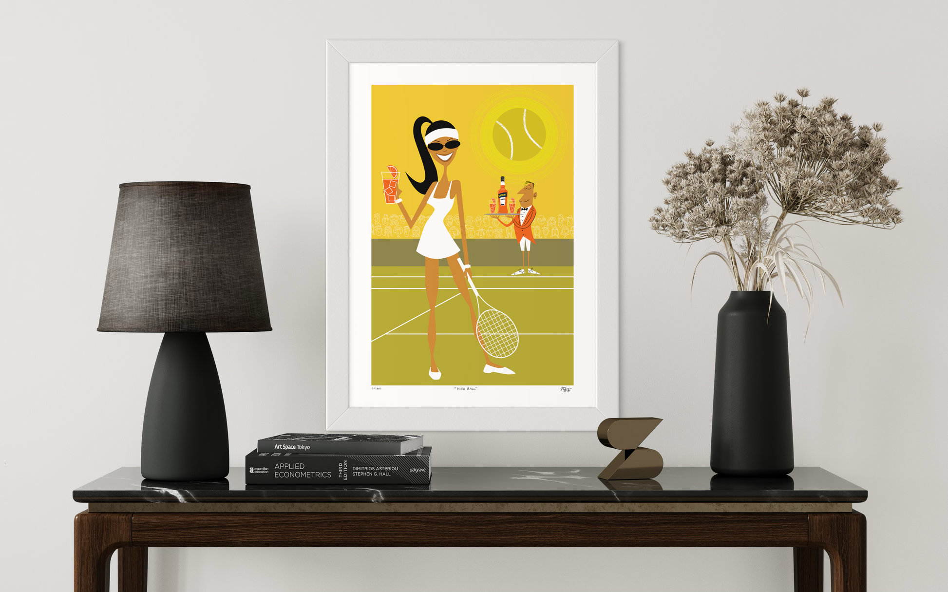 Framed artwork of a woman playing tennis on a table with decor items.