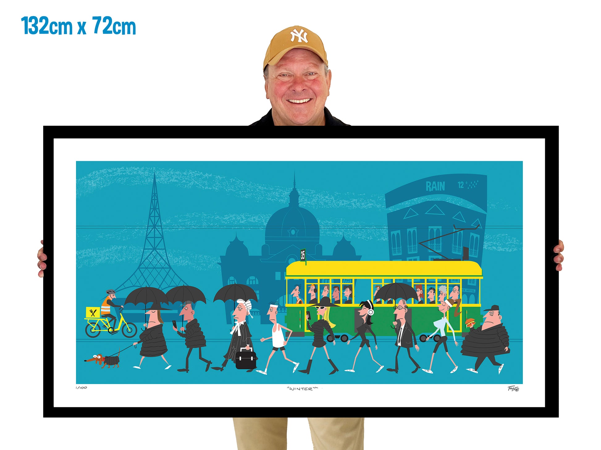 Man holding a large framed artwork of a city scene with people and a tram.